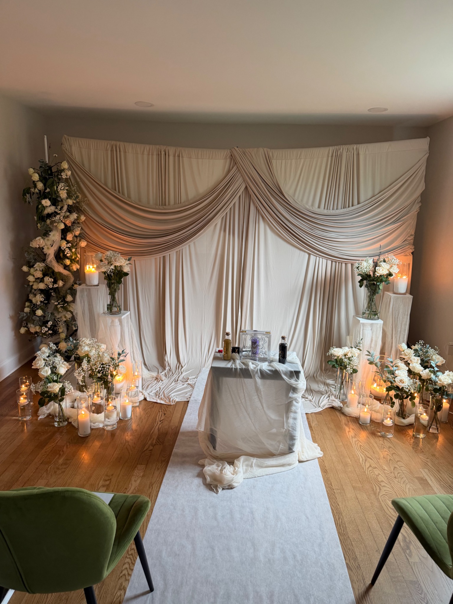 G.A.L.E. ivory and champagne draping, floral arrangements, and candlelit event setup